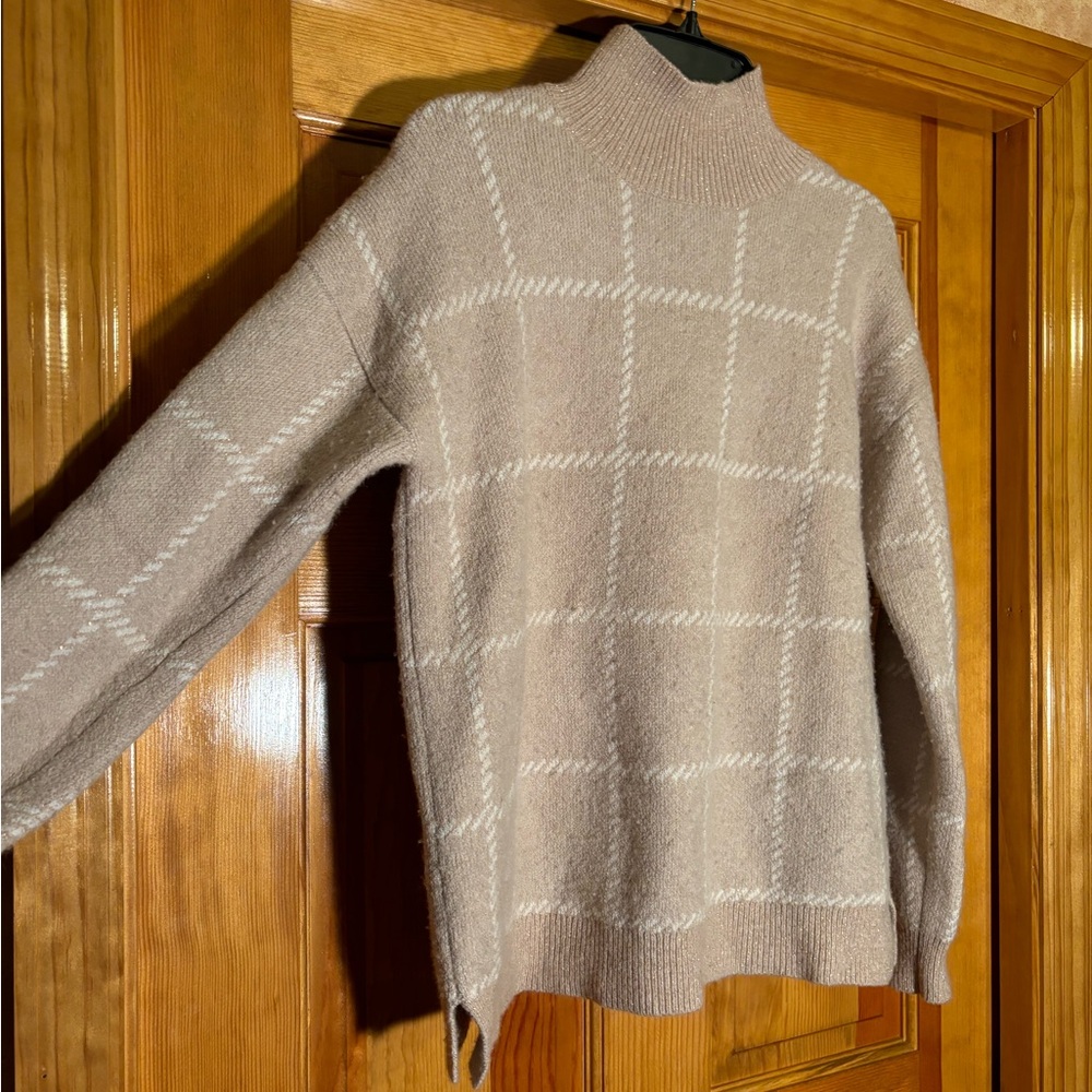 Light pink Rachael Zoe turtleneck with tinsel like sparkles throughout checkered